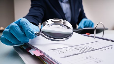 Business Fraud Investigation With Magnifying Glass