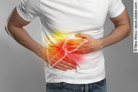 Man suffering from liver pain on grey background, closeup