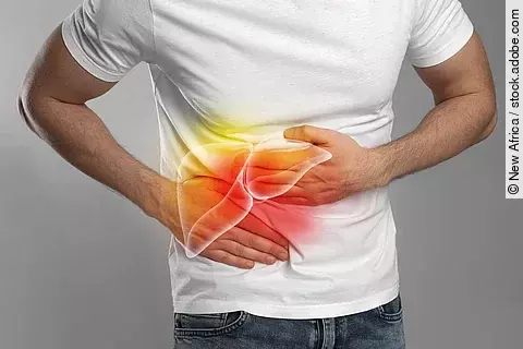 Man suffering from liver pain on grey background, closeup