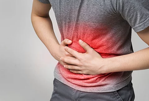 Unhealthy man suffering with stomach pain, feeling unwell Unhealthy man suffering with stomach pain, feeling unwell