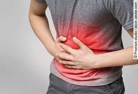 Unhealthy man suffering with stomach pain, feeling unwell