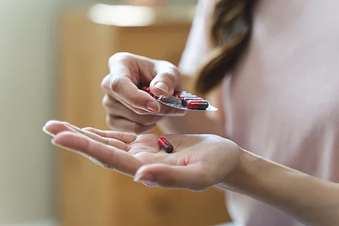 Healthcare Harmony: Close-Up Hands Holding Medication and Water 