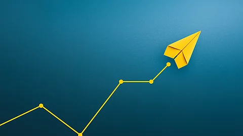 Yellow paper plane, volatility in the business and investment