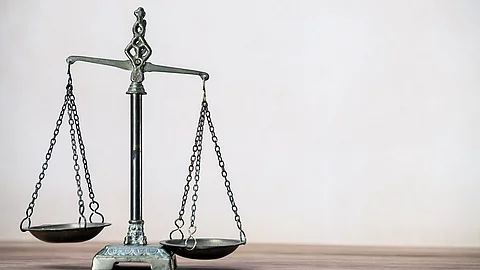 Law scales on wooden desk concept for justice and equality