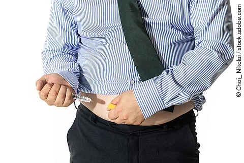 A man injecting himself with obesity medication