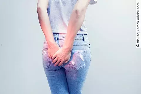 Woman hand holding her bottom because having Abdominal pain and 