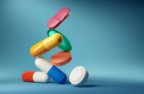 Medical balancing act. A group of medicine pills and antibiotics balancing on top of each other. 3D render illustration.