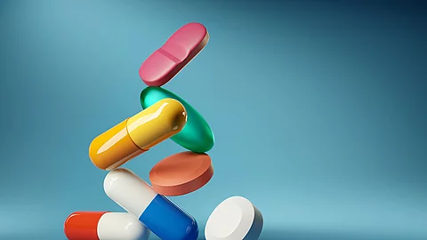 Medical balancing act. A group of medicine pills and antibiotics balancing on top of each other. 3D render illustration. Medical balancing act. A group of medicine pills and antibiotics balancing on top of each other. 3D render illustration.