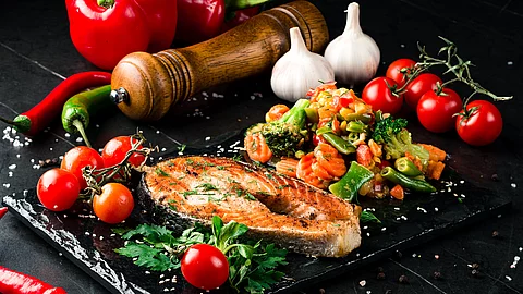 Steam salmon and vegetables, Paleo, keto, fodmap diet on old rustic wooden table Steam salmon and vegetables, Paleo, keto, fodmap diet on old rustic wooden table