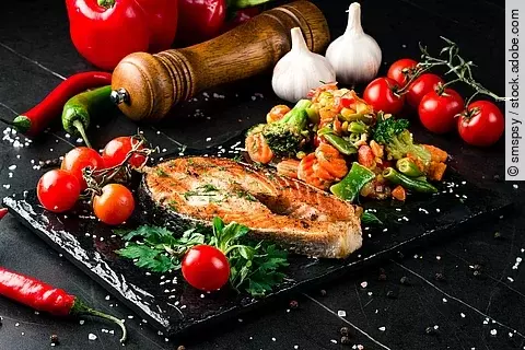 Steam salmon and vegetables, Paleo, keto, fodmap diet on old rustic wooden table