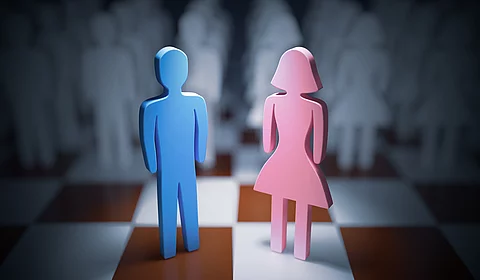 Man and woman standing on chess board. Gender equality concept. Man and woman standing on chess board. Gender equality concept.
