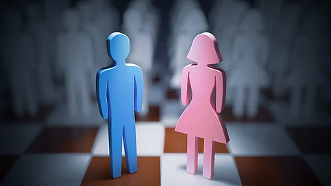 Man and woman standing on chess board. Gender equality concept.