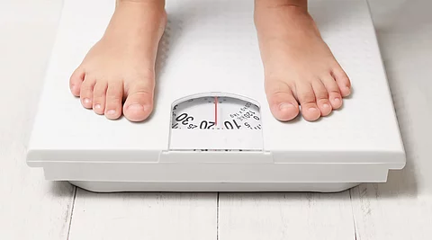 kids feet on white weight scale