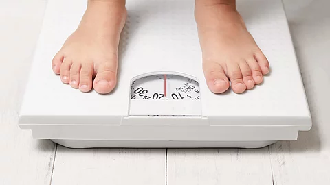 kids feet on white weight scale