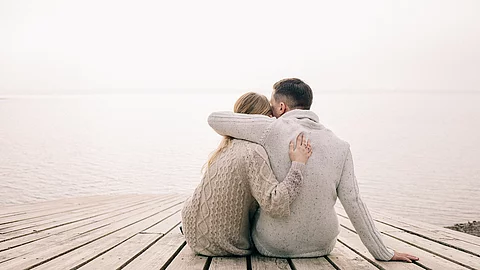 couple hugging on a pier