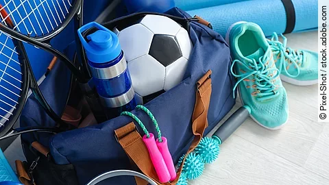 Set of sport equipment on floor near color wall