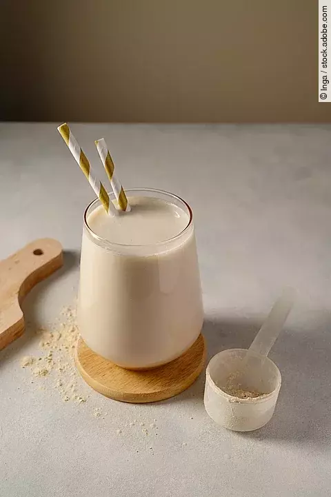 Healthy chocolate protein shake drink with straw, and protein powder